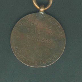 Tom's winning team medal